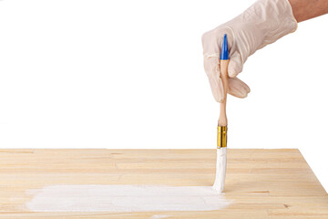 white paint with a brush painting a wooden background with texture