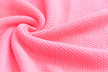 Gentle light pink textured jersey sweater folded surface as background