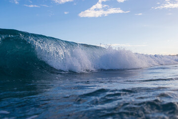 Close-up view of wave barrel breaking in the ocean.