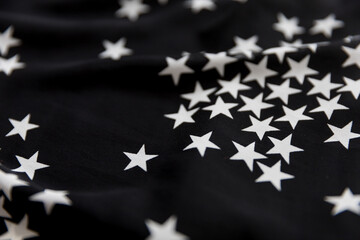 Black folded fabric with white stars pattern as texture background