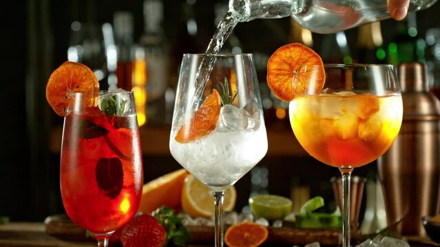 Super slow motion of preparing cocktail drinks with speed motion. Filmed on high speed cinema camera, 1000 fps, placed on high speed cine bot. Bar with bottles on background.