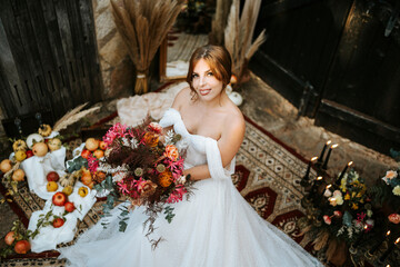 Beautiful bride in rustic arrangement by sunset