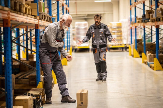 Warehouse Situation, Young Worker Comes To Help Senior Worker, He Got Injured When Carring Heavy Boxes