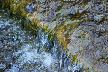 Scenery of a small stream waterfall in the mountain.
