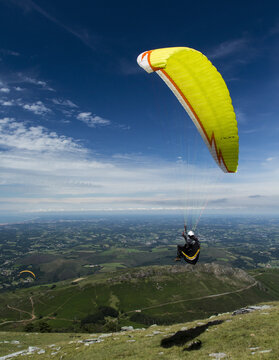 A man flying a paraglider.