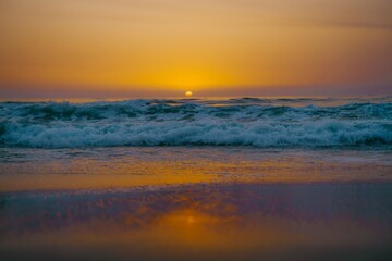 Obraz premium troubled sunset on the beach in blue and yellow tones