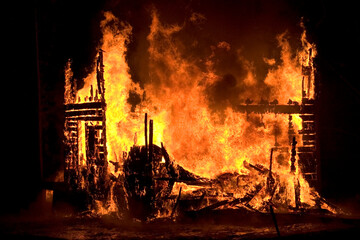The burning remains of a house.