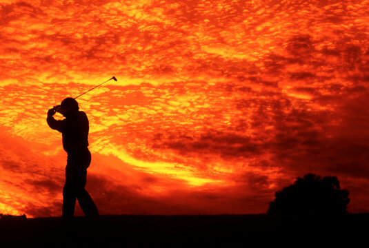 Graphic of golfer and beautiful colored sunset with dramatic clouds