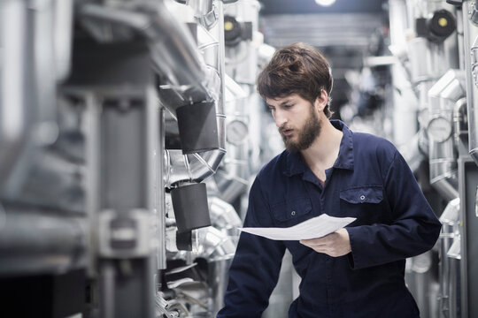 Young male engineer working in an industrial plant, Freiburg im Breisgau, Baden-Württemberg, Germany