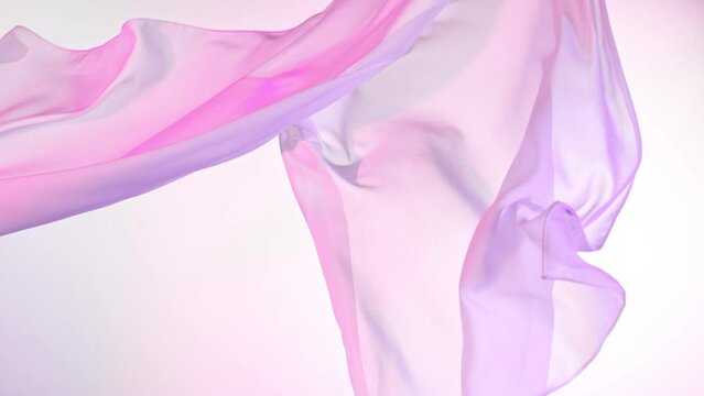 Pastel color transparent silk fabric flowing by wind, super slow motion. Fiilmed on high speed cinematic camera at 1000 fps.