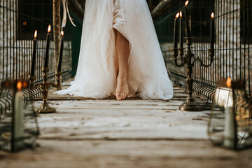 Leg of bride on bridge full of candles