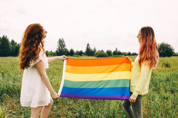 Homosexual couple holding lgbt flag, front view.
