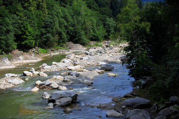 Flow of a mountain river with stones