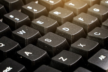Closeup of black computer keyboard with sunlight