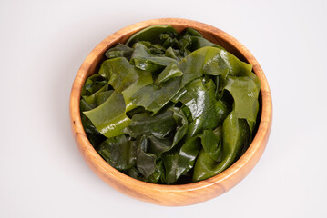 Seaweed wakame in wooden bowl isolated on gray background. japanese food © Nikox2