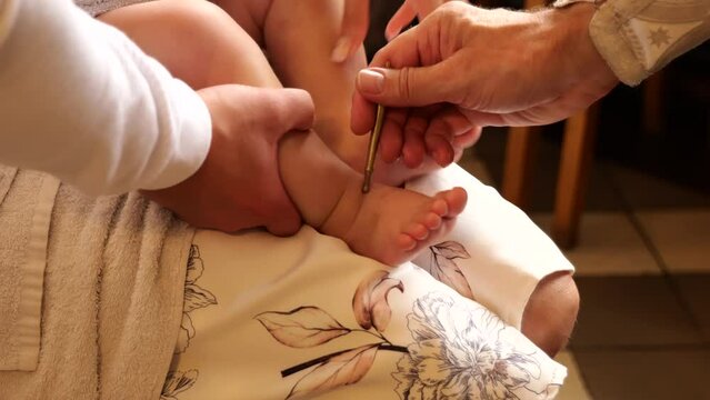 The sacrament of baptism. Newborn baby during christening.