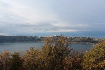 
View of Albano lake near Castelgandolfo and the summer palace of the Pope, general view of Nemi lake and houses in Nemi town, fountain, sales counter of wild strawberries, Lazio Rome Italy