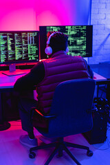 Software developer coding on his computer. Coding and hacking concept.