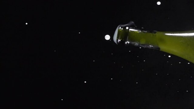 Super slow motion shot of champagne explosion, opening champagne bottle closeup. Filmed on high speed cinema camera, 4k1000fps