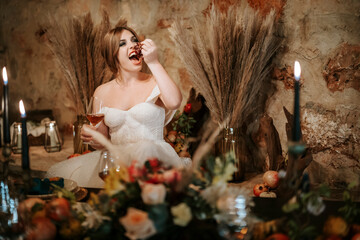 Beautiful bride by wedding table, richly decorated in rustic style