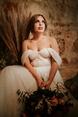 Portrait of beautiful bride with  bouquet in rustic settings