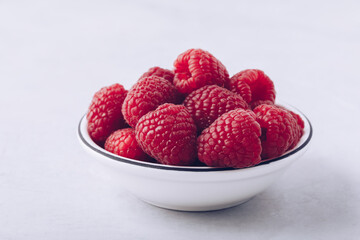 Raspberry. Fresh organic juicy raspberries in white bowl close-up