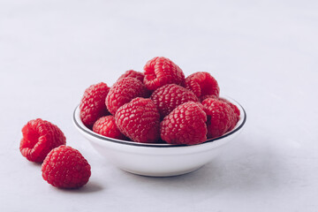 Raspberry. Fresh organic juicy raspberries in white bowl close-up