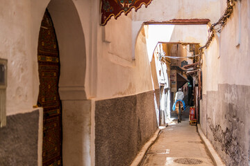 Arabic man on donkey at narrow streets of medina in Fes, Morocco, Africa