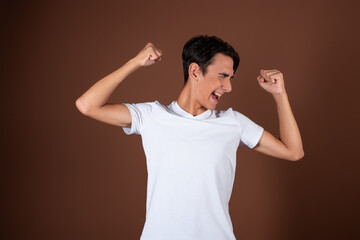 A man gesticulates against the background in the studio. Greetings, hands to the side.