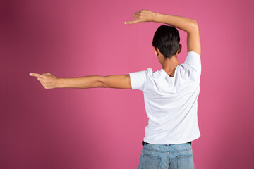 A man from behind gesticulates with his hands.