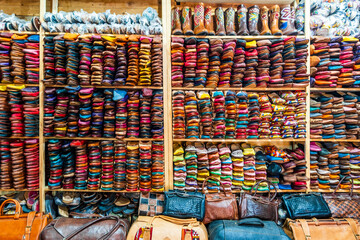 Colorful handmade leather slippers waiting for clients at shop in Fes, next to tanneries, Morocco,...
