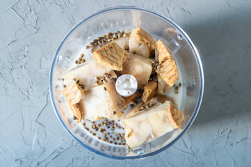 Smoothie ingredients in blender. Smoothies from banana, cookies and hemp seeds