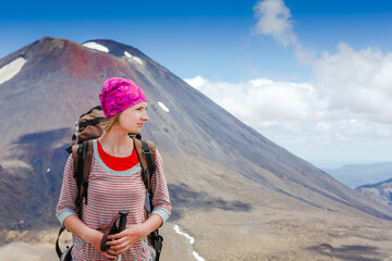 Naklejka premium Happy female hiker in New Zealand. Tongariro national park