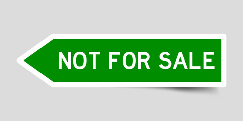 Green color arrow shape sticker label with word not for sale on gray background