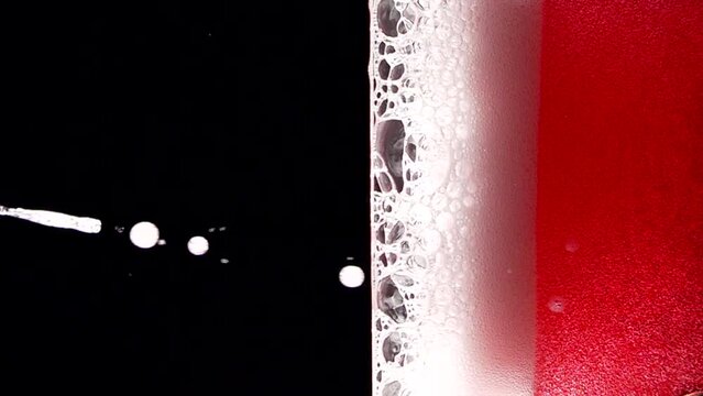 Super slow motion of clean wine glass with champagne bubbles texture filled with dry rose wine. Filmed on high speed cinema camera, 4k 1000 fps