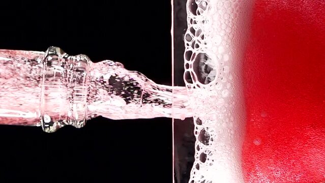 Super slow motion of clean wine glass with champagne bubbles texture filled with dry rose wine. Filmed on high speed cinema camera, 4k 1000 fps