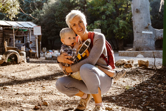 Mother hugging her two years old son wuth an airplane in Cedre Gouraud Forest in Azrou, Morocco,  Africa
