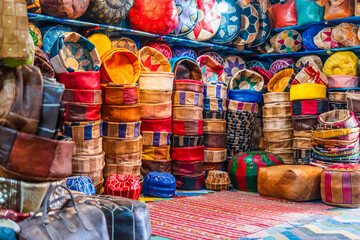 Fototapeta na wymiar Variety of leather poufs sold in huge shop next to tannery in Fes, Morocco, Africa