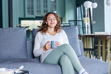 Young woman listening to music at home