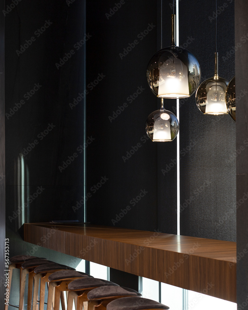Aufkleber roller blinds in the cafe. solar shades black color in the urban style interior. wooden table near t