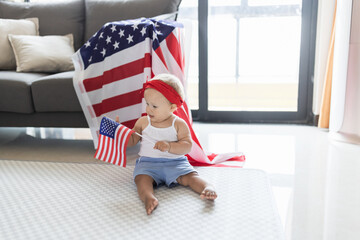 Patriotic holiday. Cute caucasian baby ten-eleven months old with blonde hair and blue eyes with...