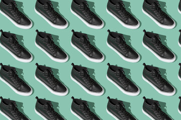 Shoe pattern. Black shoes on a blue background top view with shadow. Accessories concept. New leather shoes. Classic sport style. Fashion shoe. Flat minimalistic store advertising. Footwear.