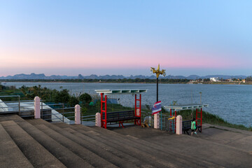 Fototapeta na wymiar Concrete stairs on the banks of the Mekong River.Exercise area on the banks of the Mekong River.The view of the Lao coastline with complex mountains.The evening view of the Mekong River.
