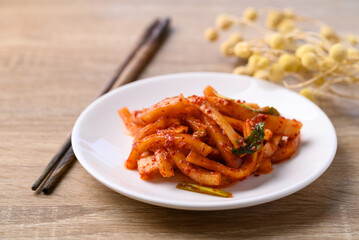 Kimchi radish on wooden table, Korean food homemade side dish