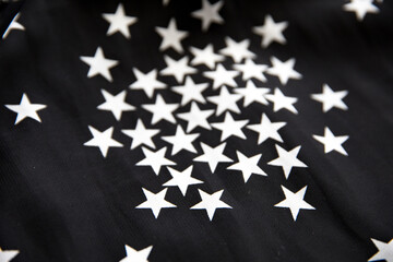 Black folded fabric with white stars pattern as texture background