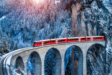 Foto op Plexiglas Landwasserviaduct Aerial view of Train passing through famous mountain in Filisur, Switzerland. Landwasser Viaduct world heritage with train express in Swiss Alps snow winter scenery.