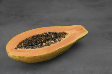 Fresh ripe papaya fruits on grey table, closeup.