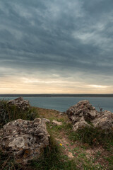 Fototapeta na wymiar Rocks with mediterraneam sea and cloudy sky | Island Dugi Otok, Croatia