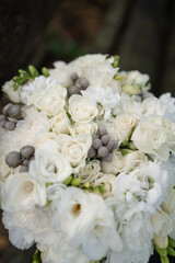 Wedding bouquet of white flowers - ranunculus, freesia, lisianthus.. Wedding. Bride and groom.