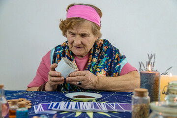 A fortune teller reads fortunes on coffee grounds. Selective focus.